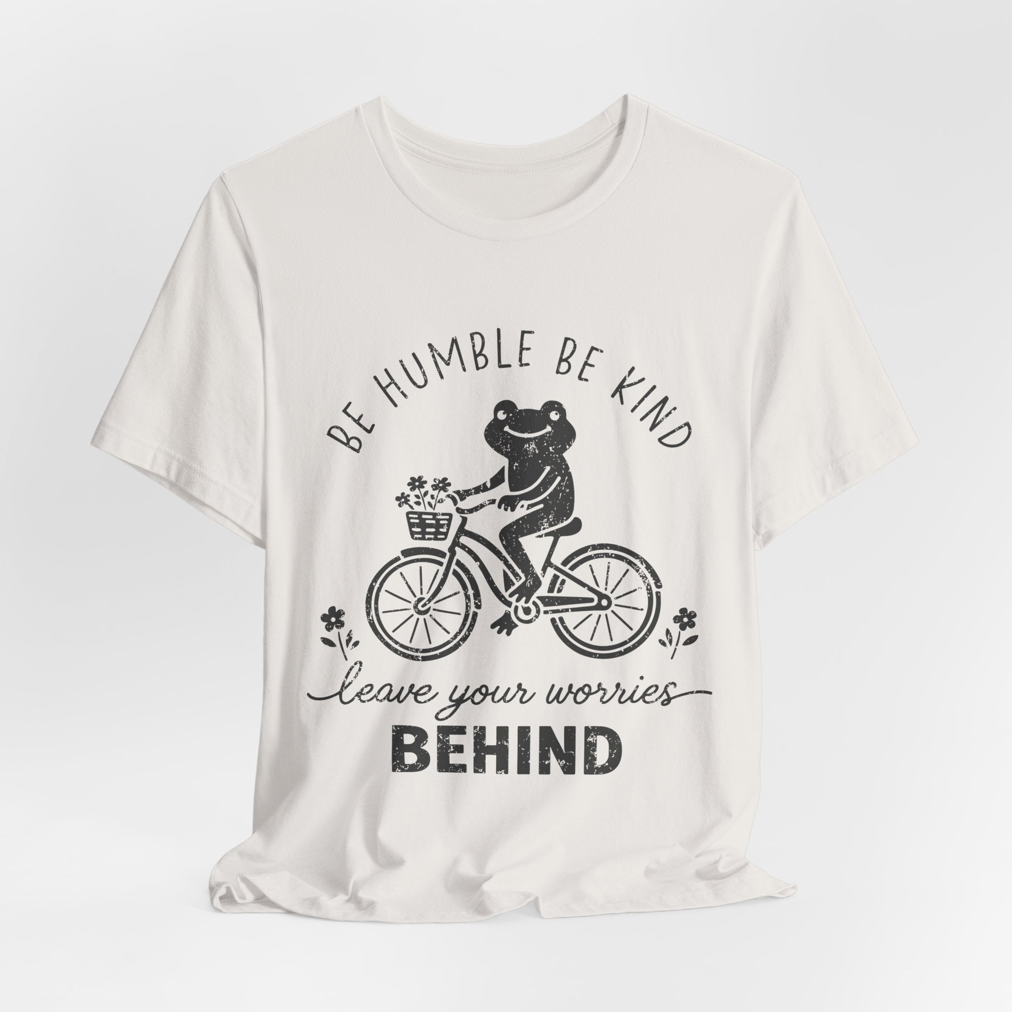 T-Shirt — "Be Humble Be Kind" Frog on Bike Graphic Tee, "Leave Your Worries Behind"