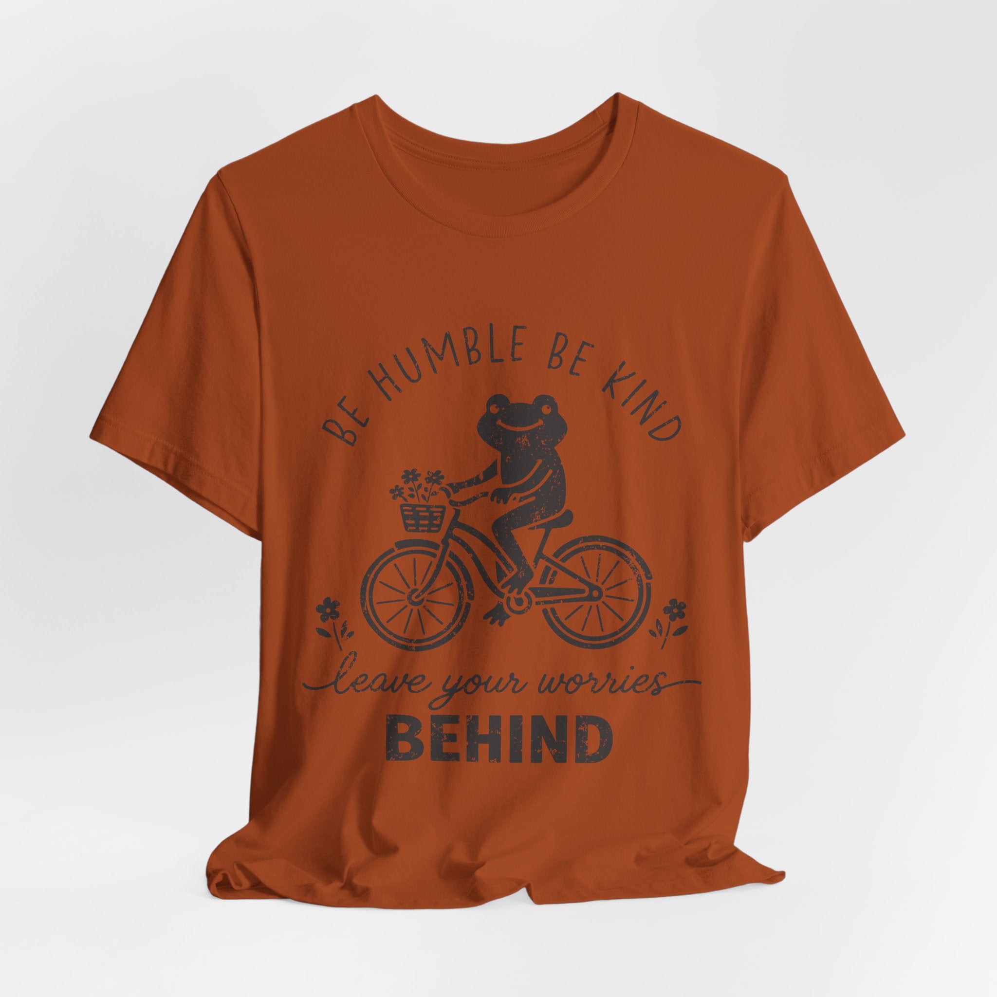 T-Shirt — "Be Humble Be Kind" Frog on Bike Graphic Tee, "Leave Your Worries Behind"