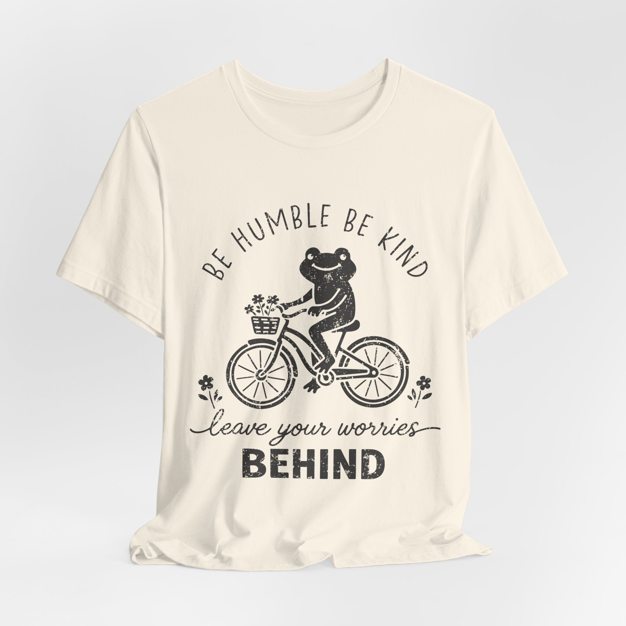 T-Shirt — "Be Humble Be Kind" Frog on Bike Graphic Tee, "Leave Your Worries Behind"
